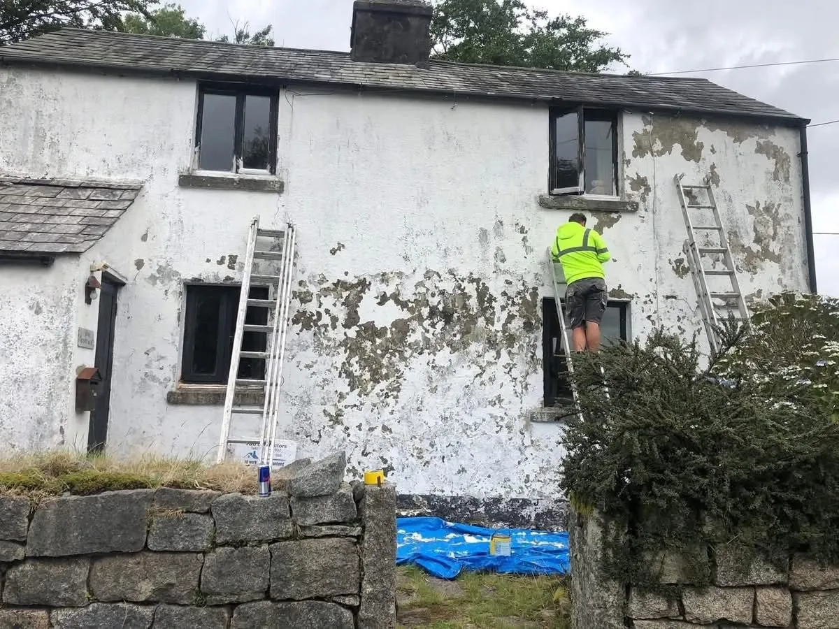 Cottage with blown, flaking render before repair in St Blazey